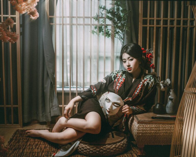 Beautiful woman in a kimono holds a mask in a traditional Japanese setting, evoking mystery and elegance.