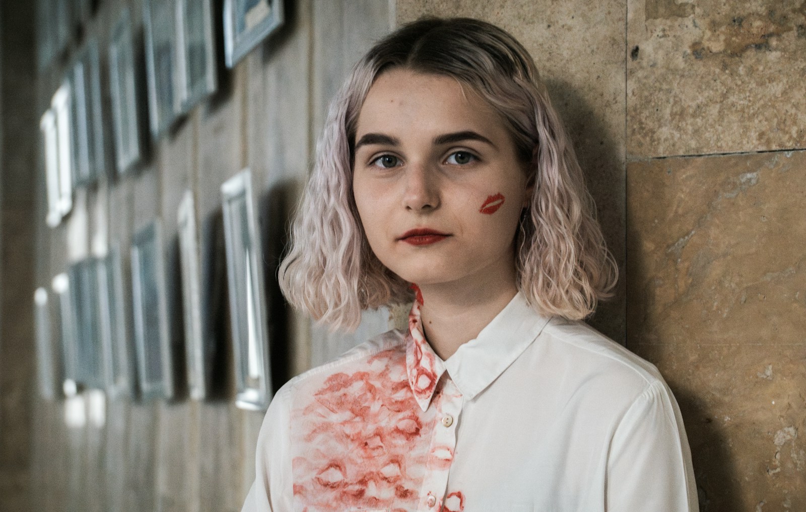 Woman with lipstick and a blood-like stain.