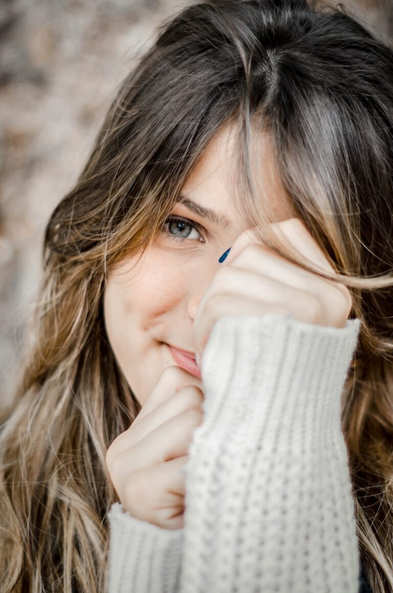 woman holding her face