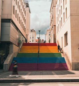 Vibrant rainbow stairs in a city scene, perfect urban street art photo.